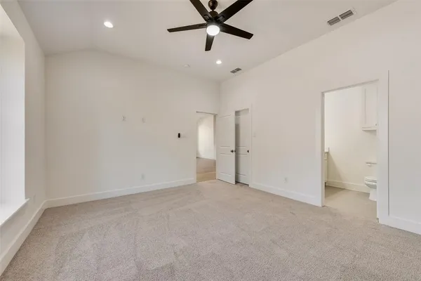 wooden floor in an empty room and a ceiling fan