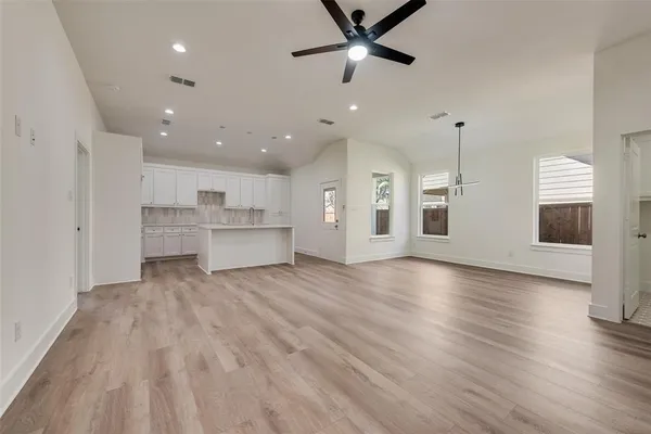 a view of a kitchen with a sink and wooden floor