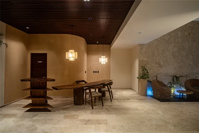 a view of a hallway with furniture and window