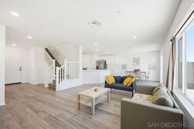 a living room with furniture window and wooden floor