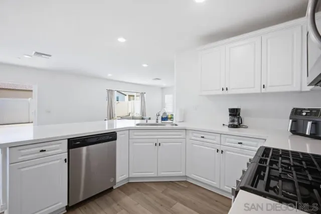 a kitchen with stainless steel appliances a refrigerator sink and cabinets