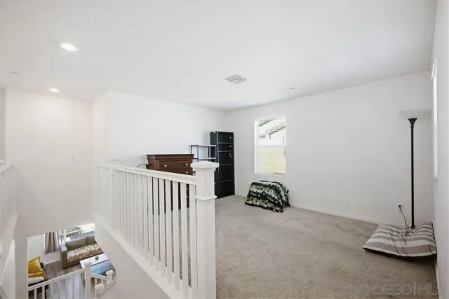 a view of a hallway with workspace and a window