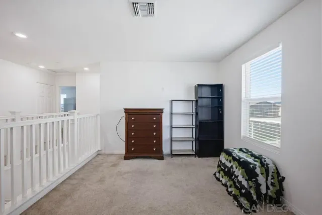 a room with a window and a ceiling fan