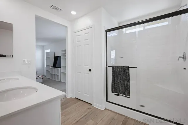 a bathroom with a double vanity sink and a mirror