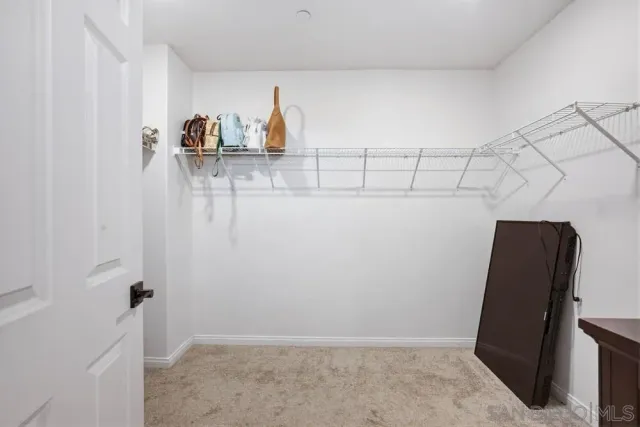 a view of a utility room with closet and windows