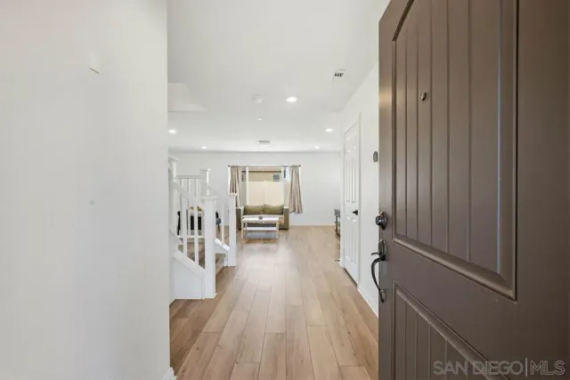 a view of an entryway with wooden floor