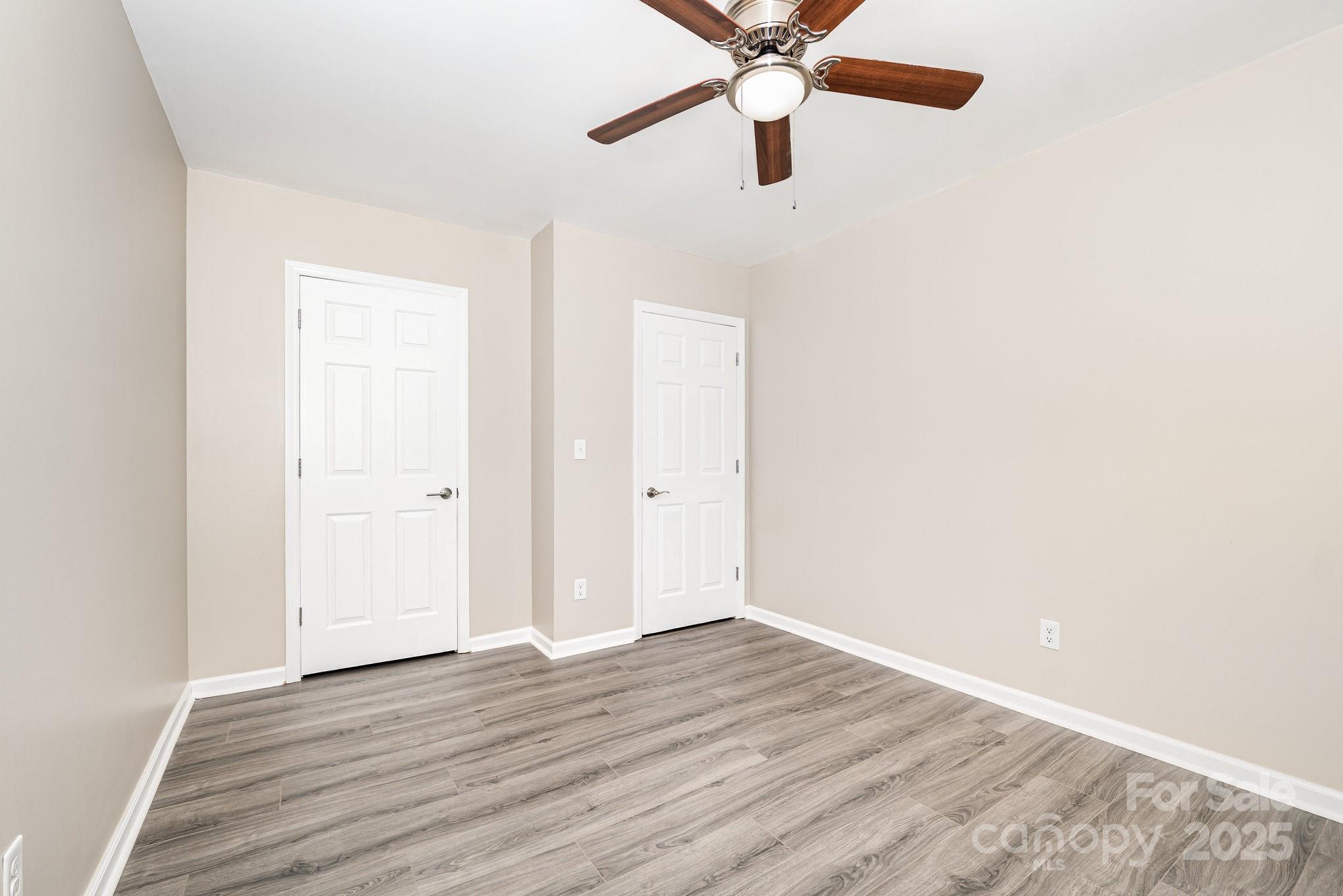 152 Sparrow Road Statesville, NC 28625 - Photo 13 of 28 an empty room with wooden floor closet and fan