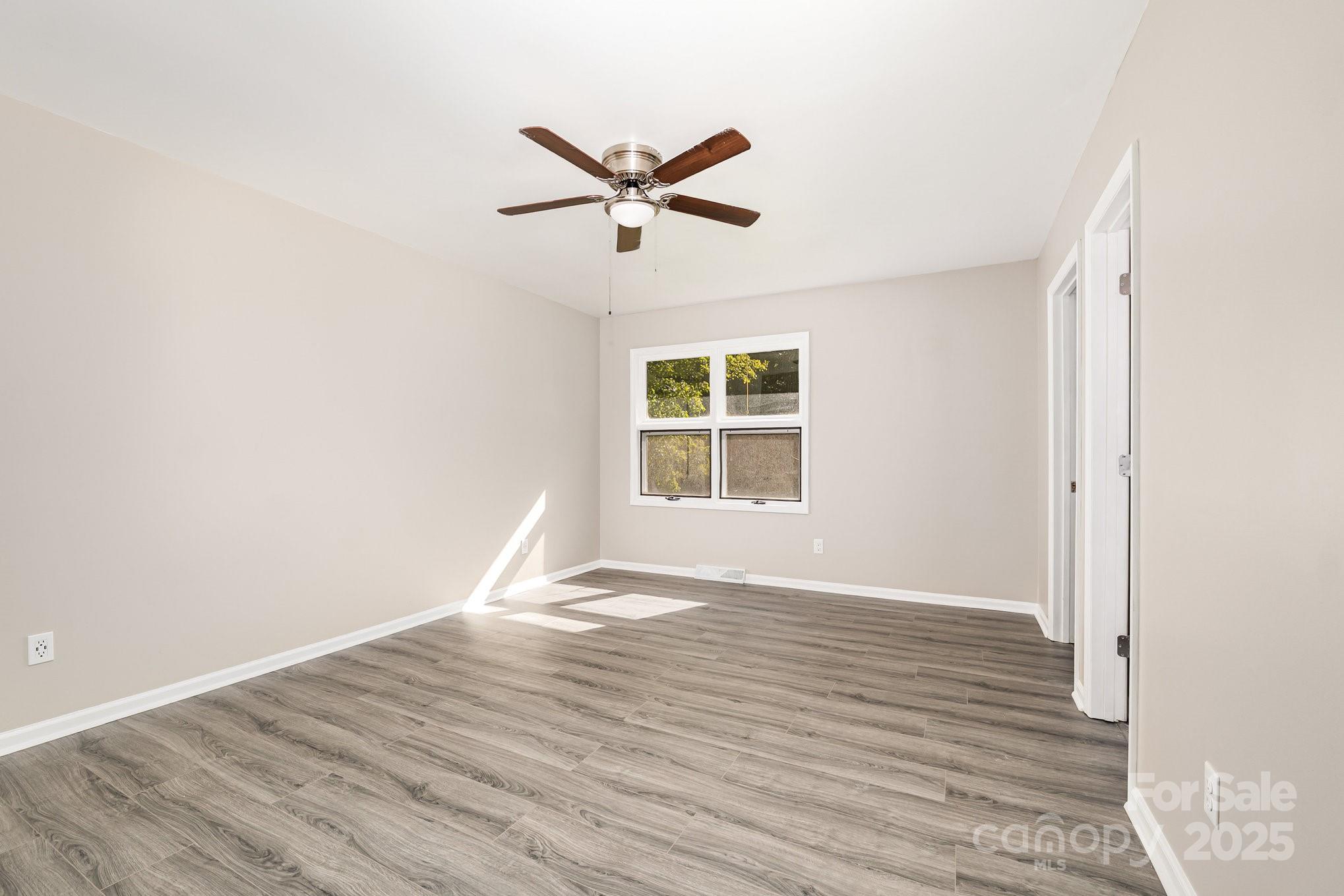 152 Sparrow Road Statesville, NC 28625 - Photo 18 of 28 a view of empty room with wooden floor and fan