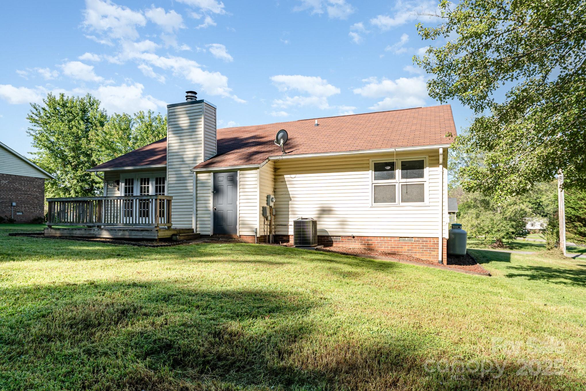 152 Sparrow Road Statesville, NC 28625 - Photo 19 of 28 a front view of a house with a garden and trees