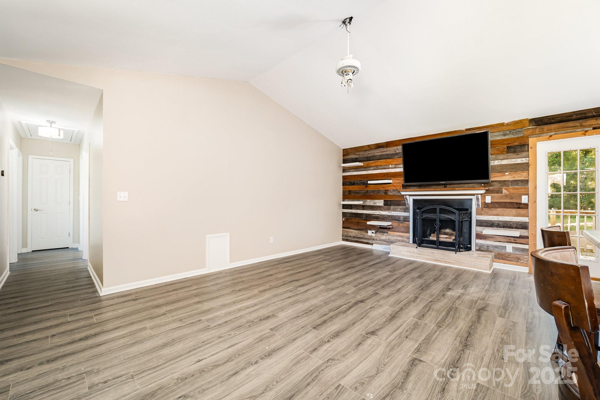 152 Sparrow Road Statesville, NC 28625 - Photo 2 of 28 wooden floor fireplace and windows in the room