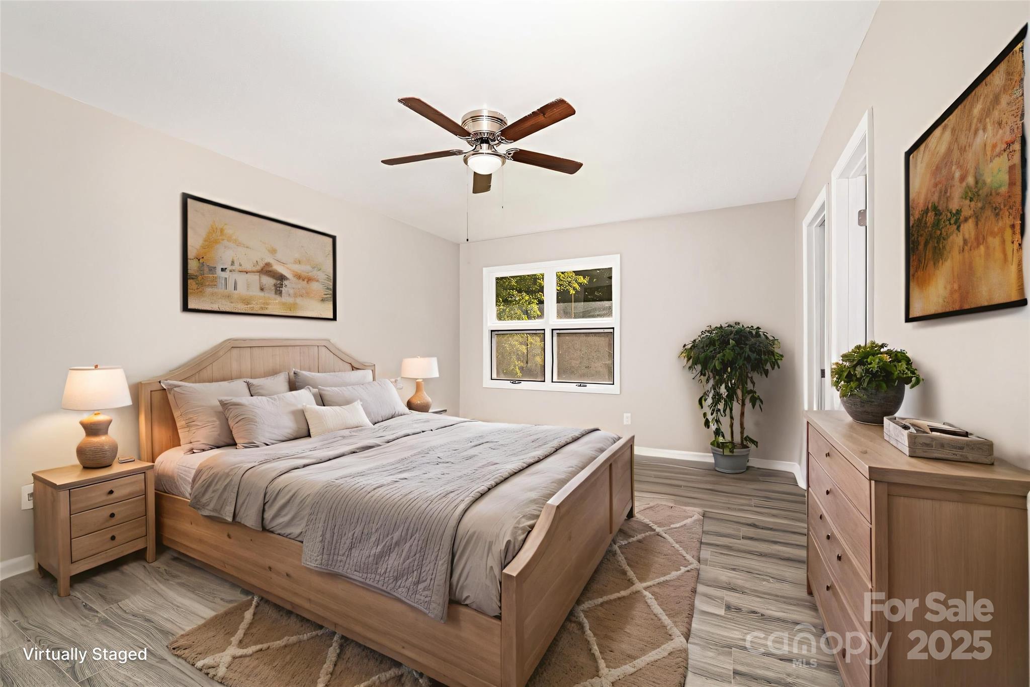 152 Sparrow Road Statesville, NC 28625 - Photo 3 of 28 a bedroom with a large bed and a potted plant