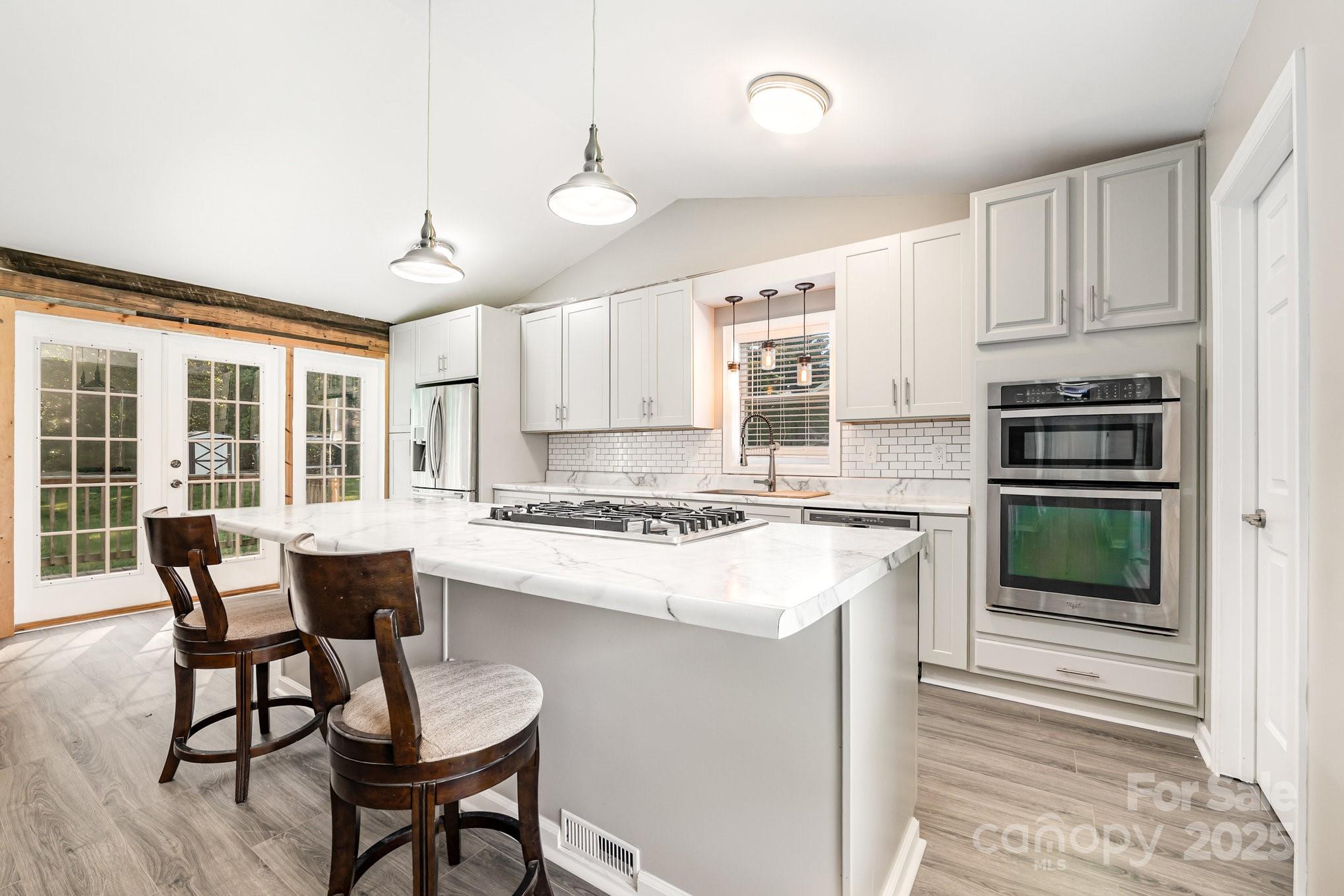 152 Sparrow Road Statesville, NC 28625 - Photo 4 of 28 a kitchen with a stove a table and chairs in it