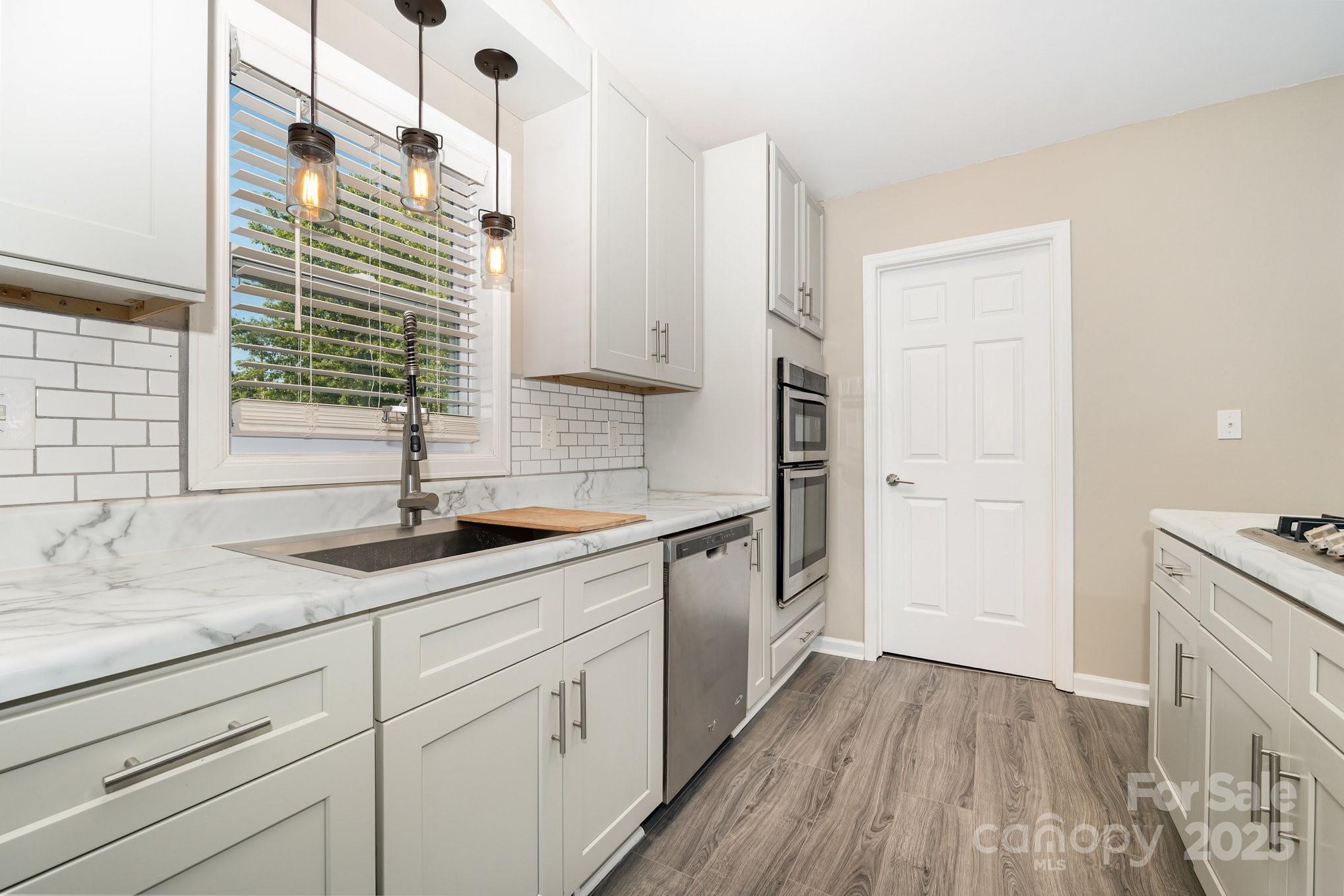 152 Sparrow Road Statesville, NC 28625 - Photo 6 of 28 a kitchen with a sink and cabinets