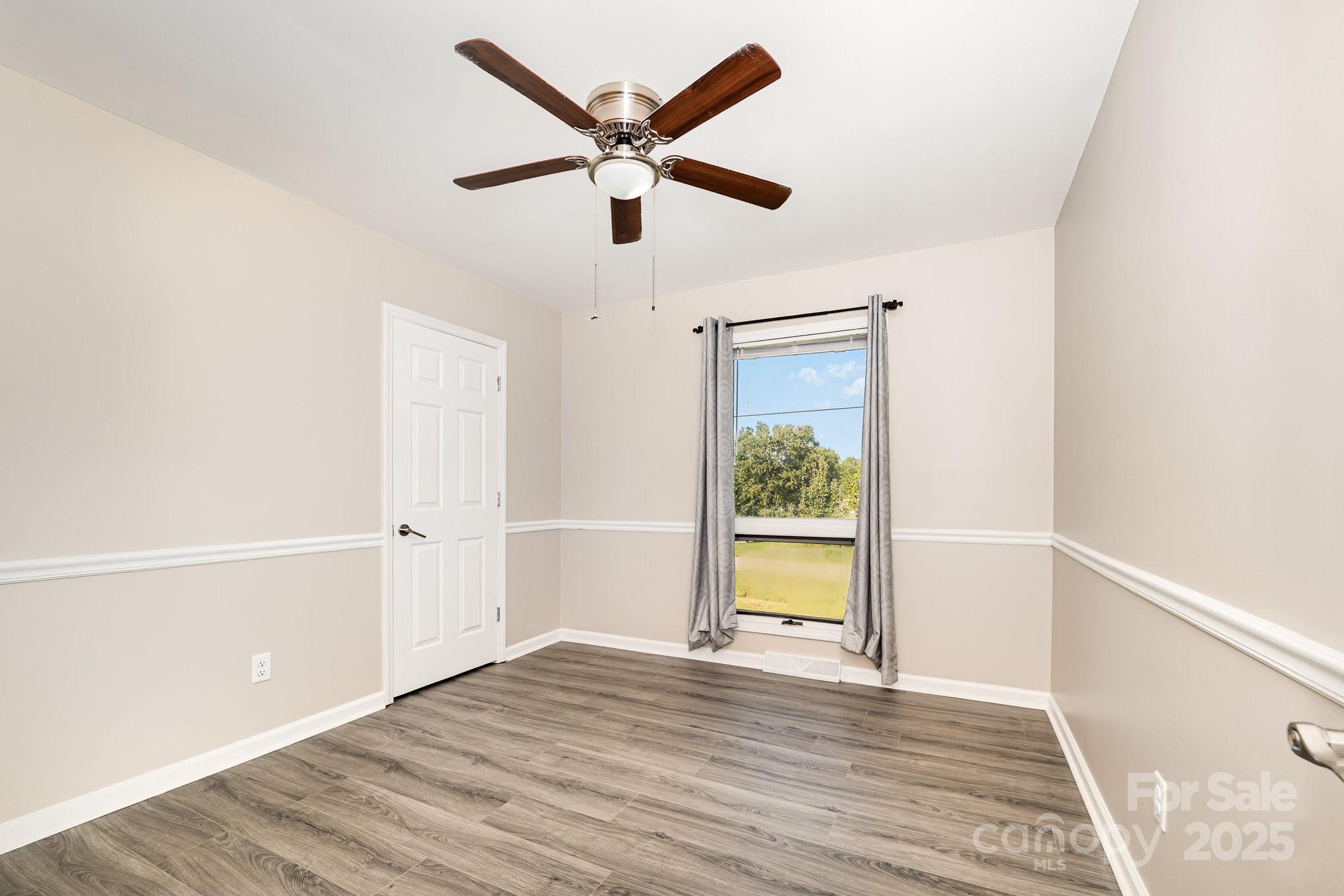 152 Sparrow Road Statesville, NC 28625 - Photo 9 of 28 a view of empty room with wooden floor and fan