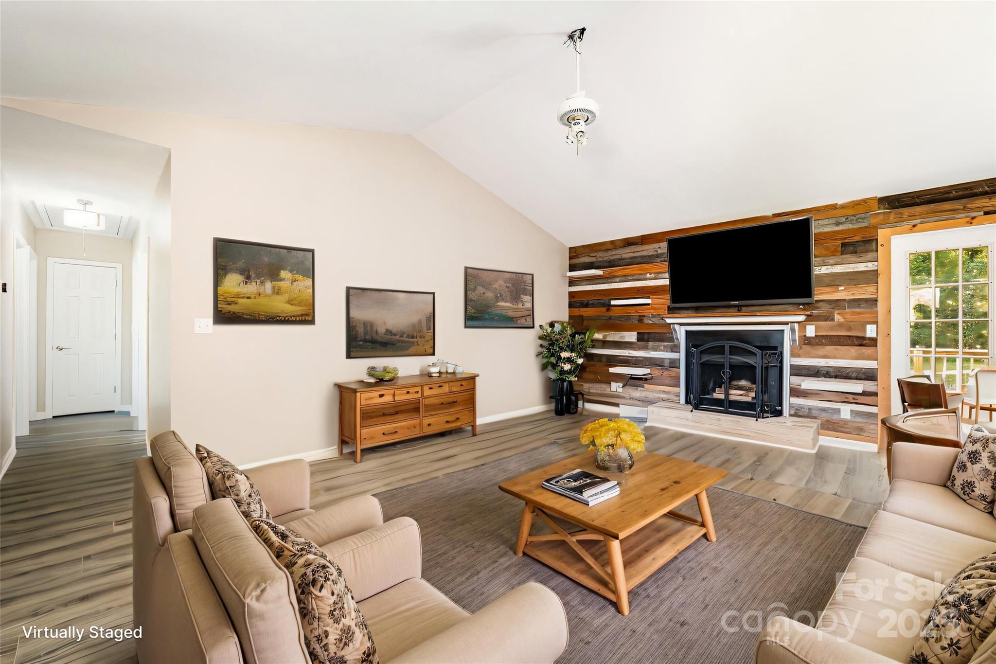 152 Sparrow Road Statesville, NC 28625 - Photo 10 of 28 a living room with furniture a flat screen tv and a fireplace