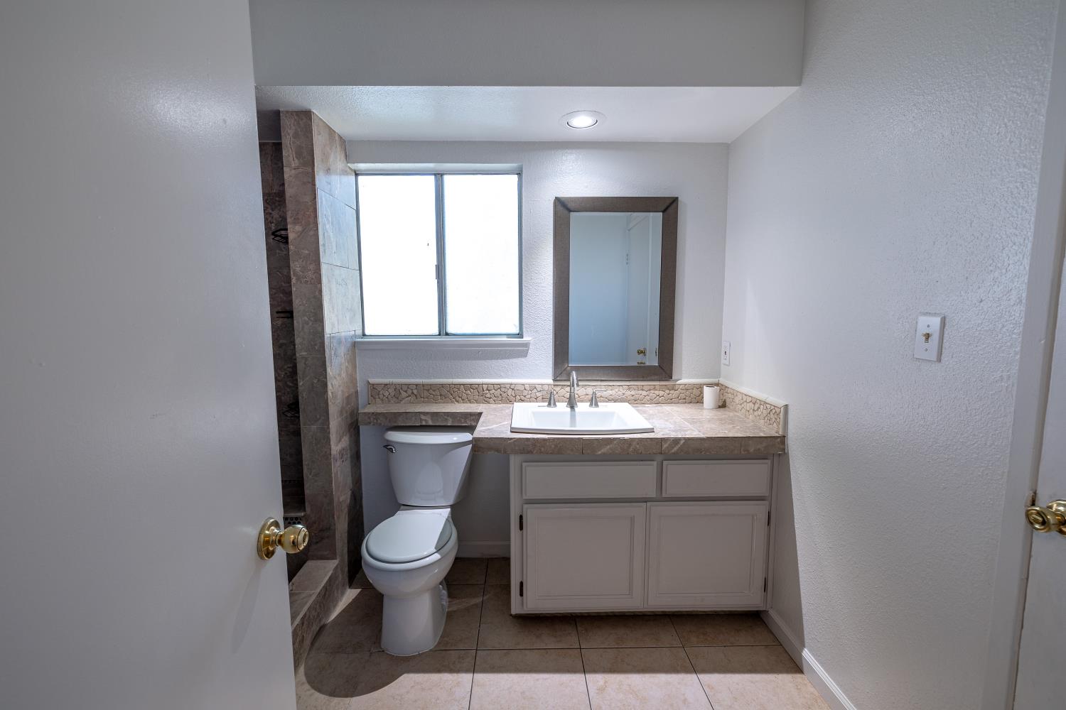 3700 Tully Road, Unit 5 Modesto, CA 95356 - Photo 17 of 38 a bathroom with a toilet sink and mirror