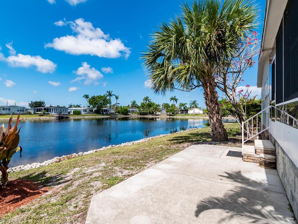 269 Riverwood Road Naples, FL 34114 - Photo 2 of 32 a view of a lake with a building in the background