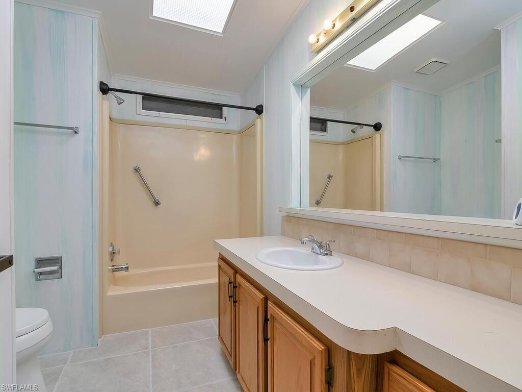 269 Riverwood Road Naples, FL 34114 - Photo 22 of 32 a bathroom with a sink a toilet and a bathtub