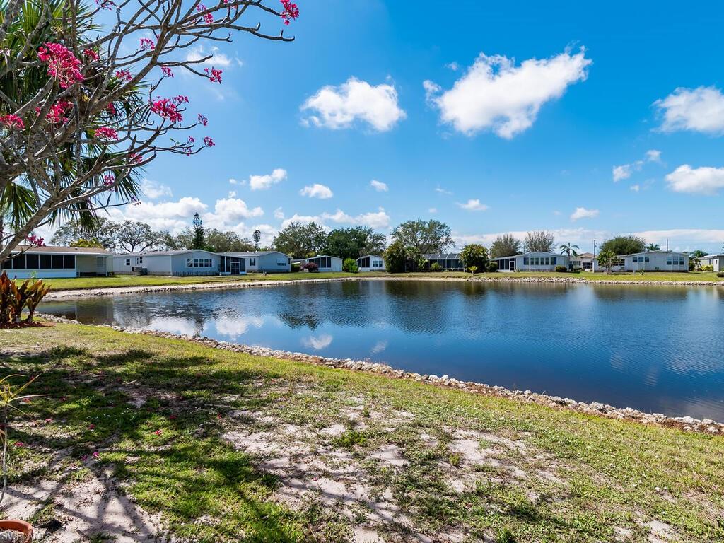 269 Riverwood Road Naples, FL 34114 - Photo 3 of 32 a view of a lake with houses in the back