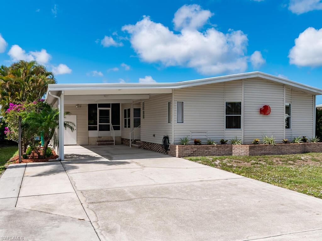 269 Riverwood Road Naples, FL 34114 - Photo 4 of 32 a view of a house with backyard and sitting area