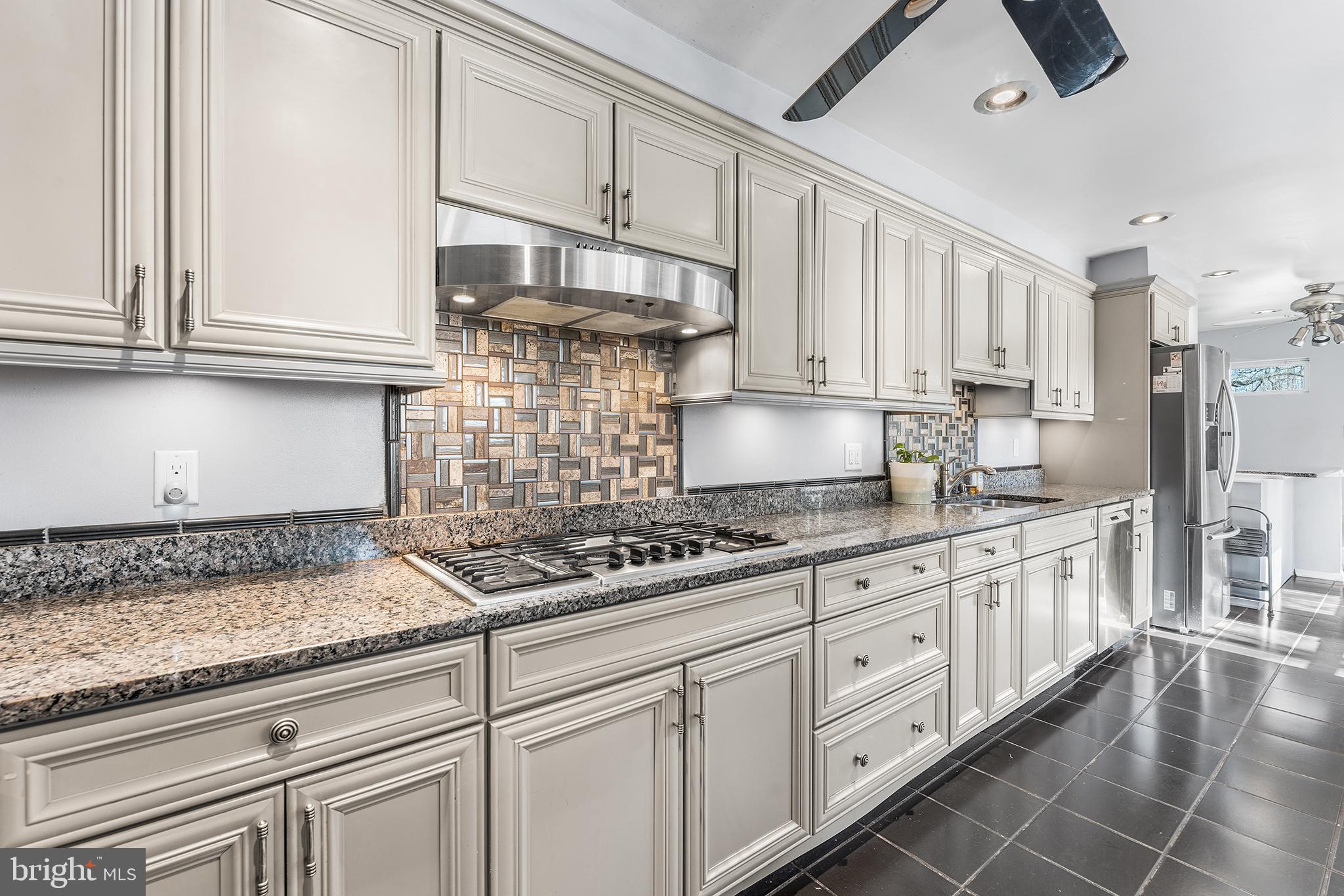 295 Braddock Avenue Lansdowne, PA 19050 - Photo 12 of 36 a kitchen with granite countertop white cabinets and white appliances