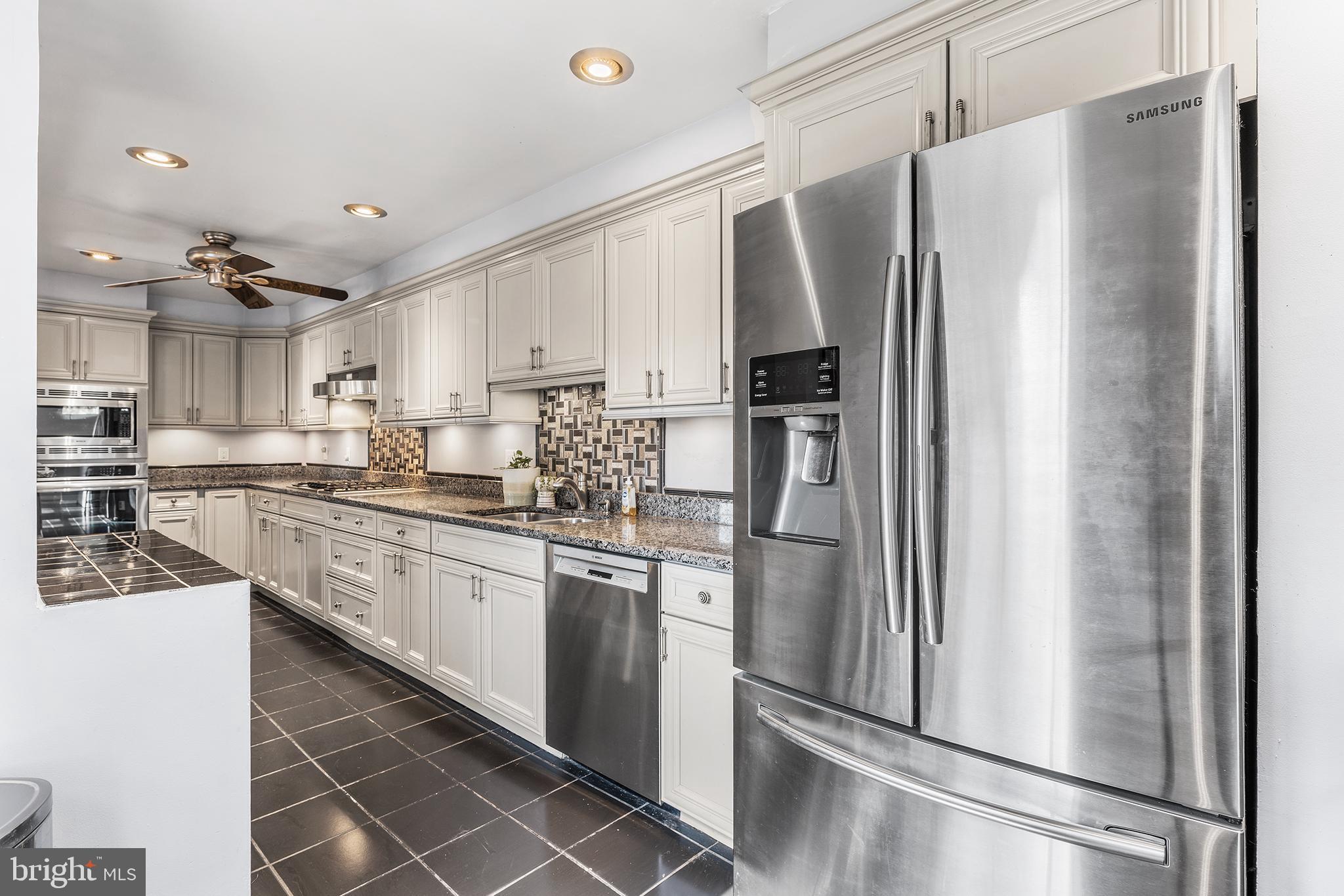 295 Braddock Avenue Lansdowne, PA 19050 - Photo 14 of 36 a kitchen with stainless steel appliances a refrigerator sink and cabinets