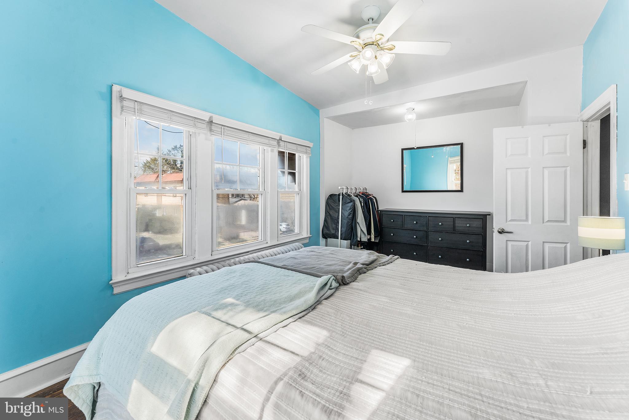 295 Braddock Avenue Lansdowne, PA 19050 - Photo 20 of 36 a bedroom with a large bed and a chandelier