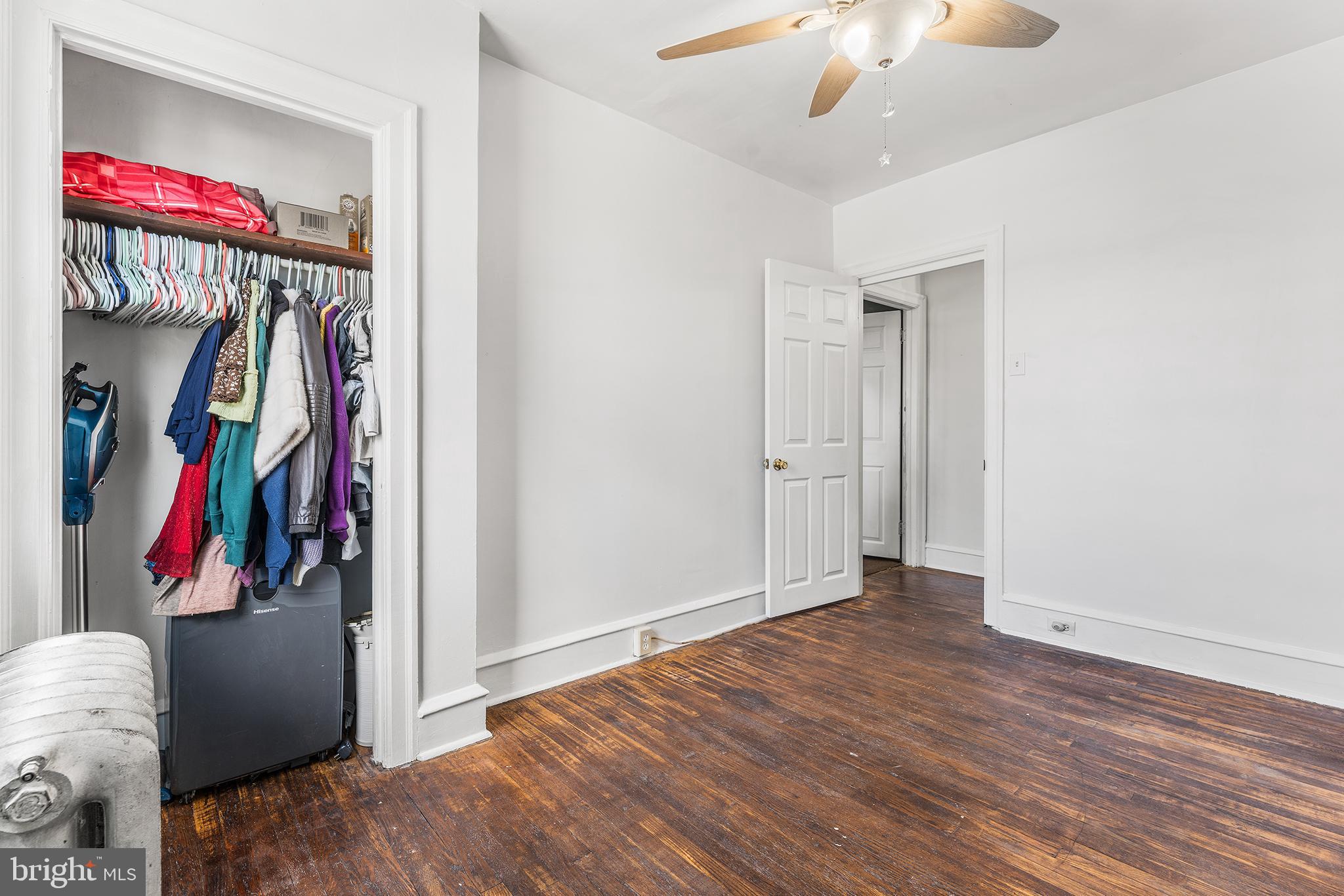 295 Braddock Avenue Lansdowne, PA 19050 - Photo 22 of 36 a view of a livingroom with wooden floor and a ceiling fan