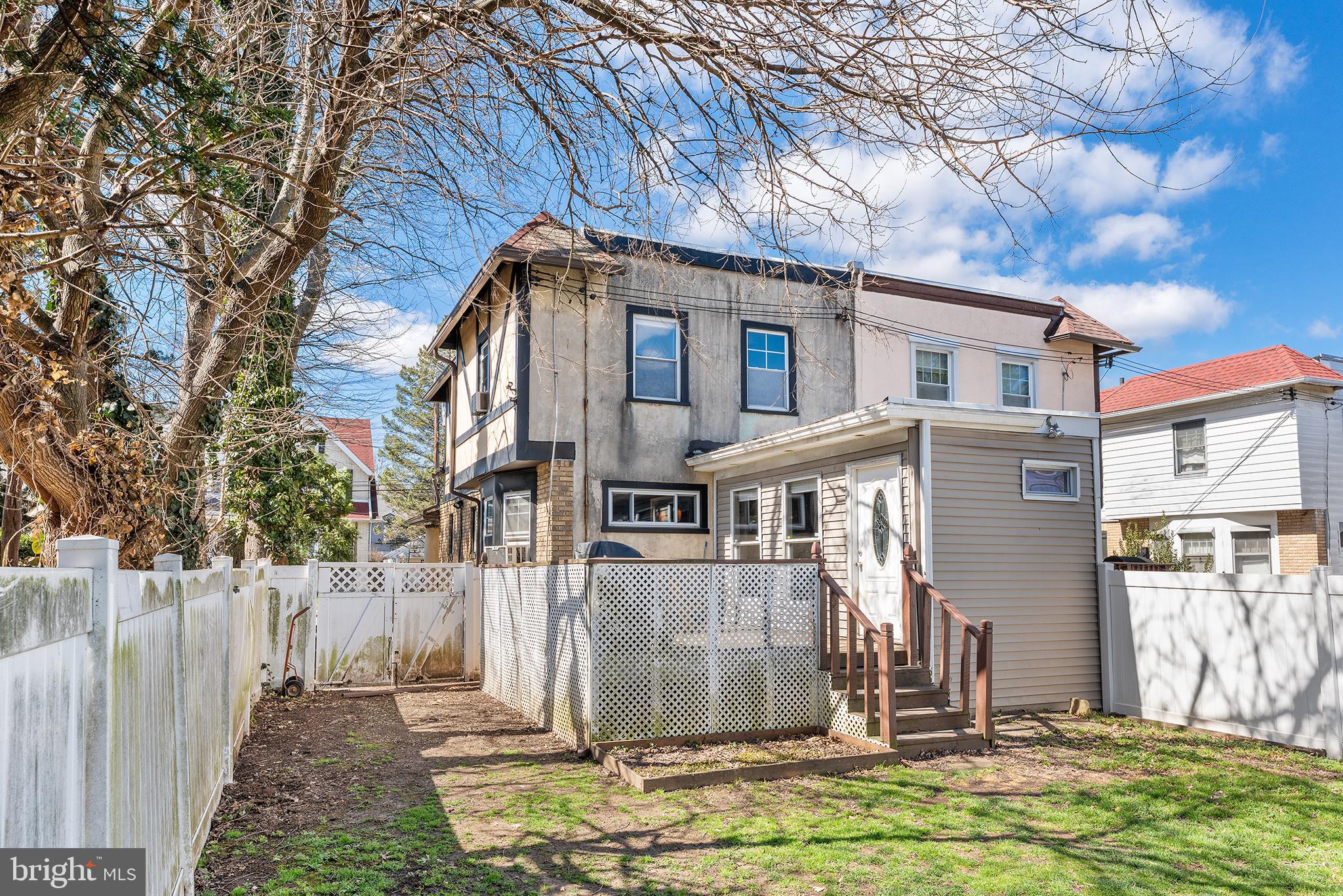 295 Braddock Avenue Lansdowne, PA 19050 - Photo 35 of 36 a view of a white house with large windows and a small yard