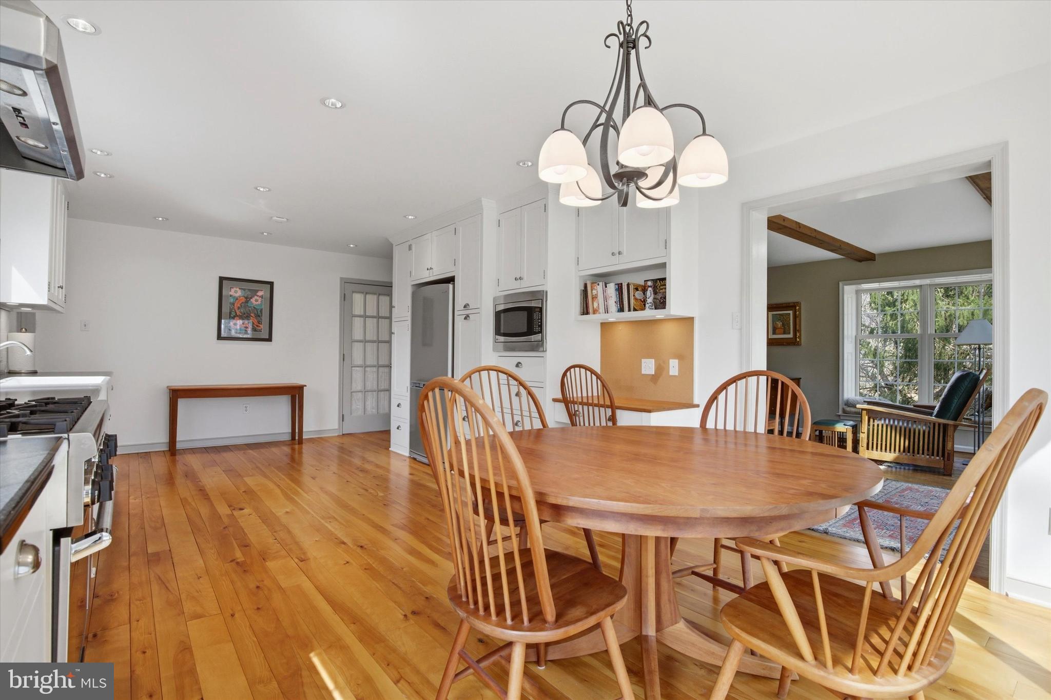1307 Jaine Lane Spring City, PA 19475 - Photo 14 of 47 a dining room with wooden floor a chandelier a wooden table and chairs