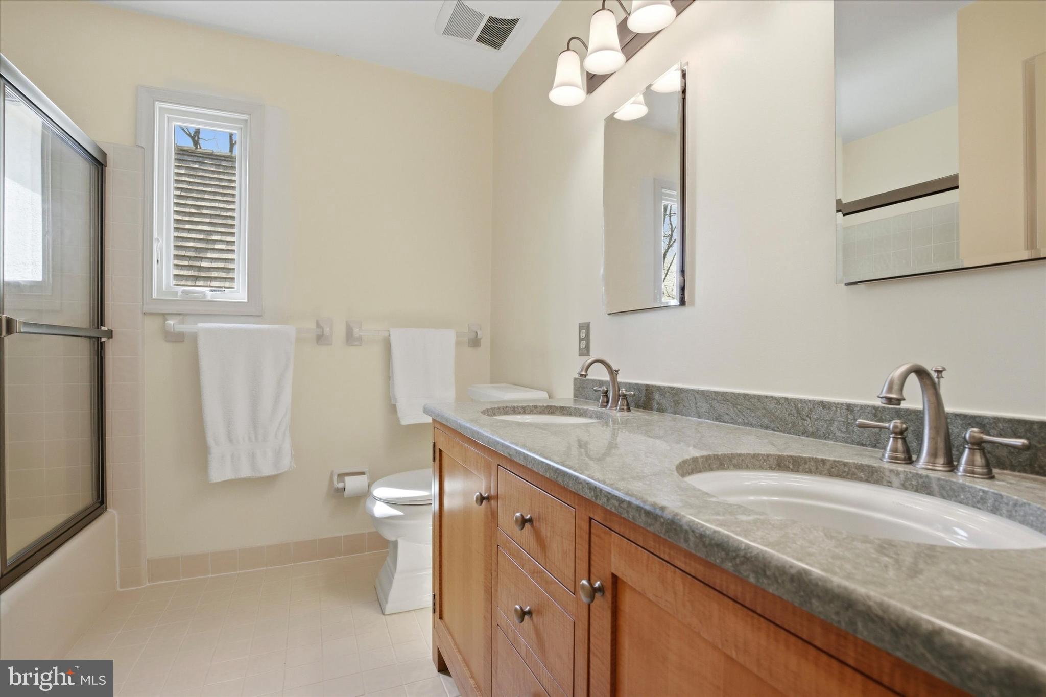 1307 Jaine Lane Spring City, PA 19475 - Photo 33 of 47 a bathroom with a granite countertop sink mirror and a toilet