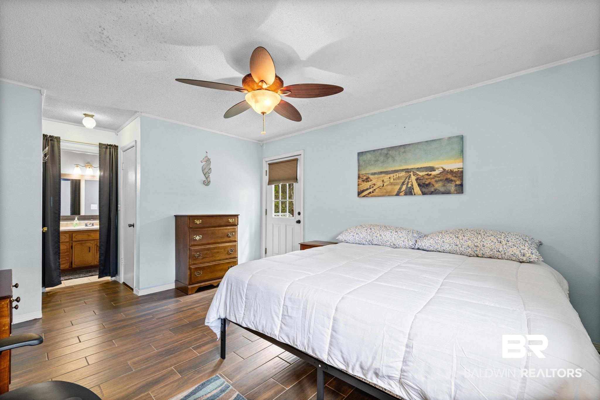 1437 Rio Circle Lillian, AL 36549 - Photo 16 of 46 Bedroom with ornamental molding, wood finish floors, ceiling fan, a textured ceiling, and ensuite bath