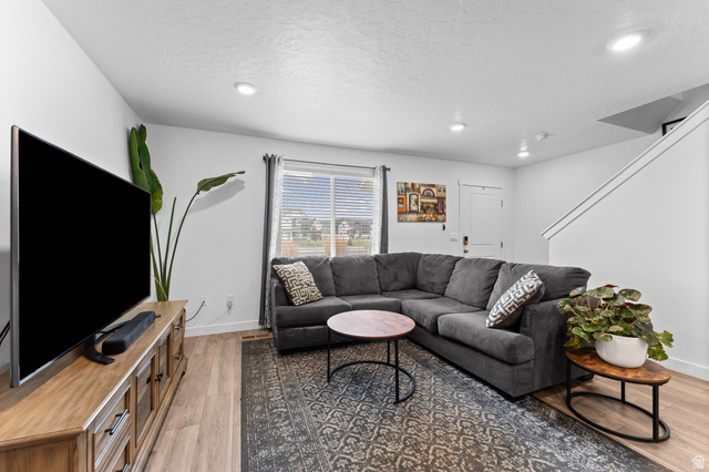 878 North Old Rnch Road Lehi, UT 84048 - Photo 8 of 36 Open concept living space featuring wood-finish flooring, recessed lighting, a window with blinds, and white painted walls