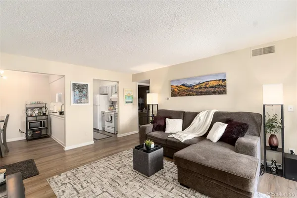 a living room with furniture and wooden floor