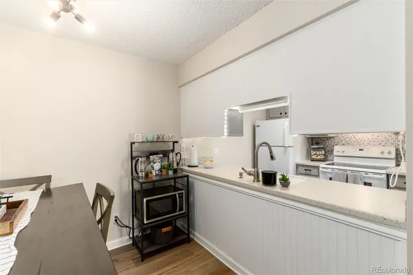 a kitchen with stainless steel appliances a stove and more cabinets