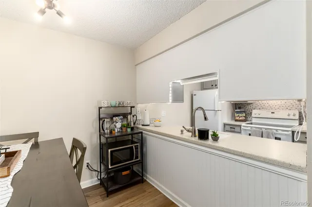 a kitchen with stainless steel appliances a stove and more cabinets