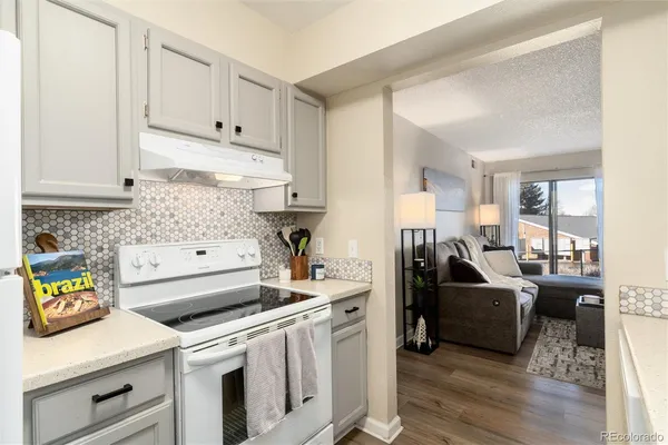 a kitchen with white cabinets and appliances