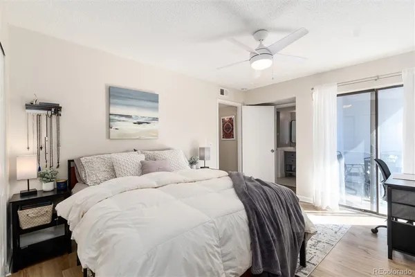 a spacious bedroom with a bed and a chandelier