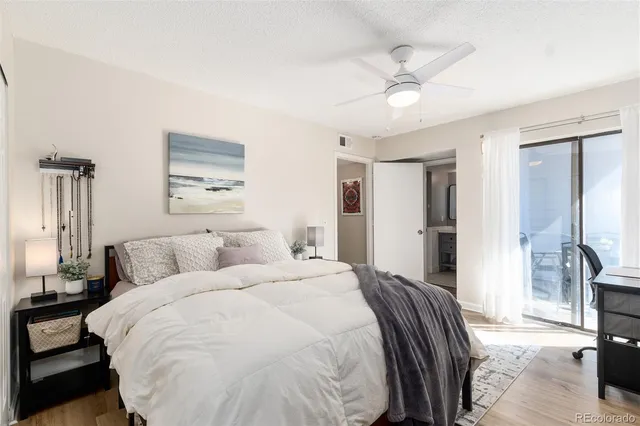 a spacious bedroom with a bed and a chandelier