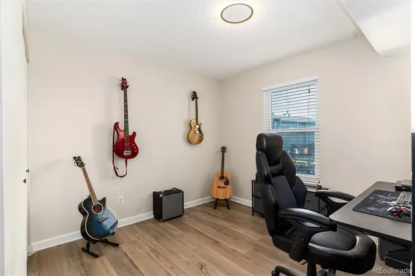 a view of a workspace with furniture and a window