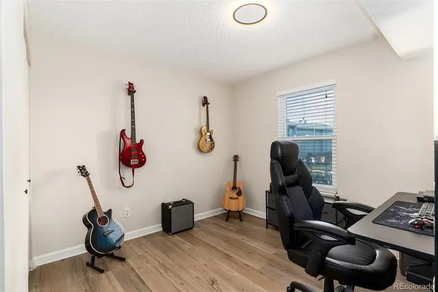 a view of a workspace with furniture and a window