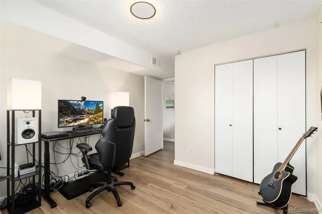 a view of a workspace with furniture and a gym cycle