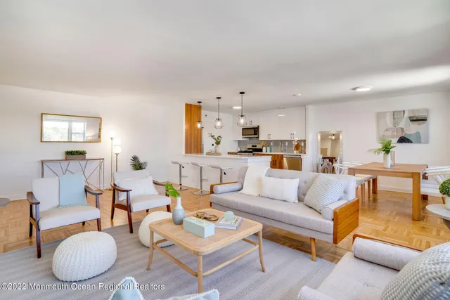 a living room with furniture kitchen view and a table