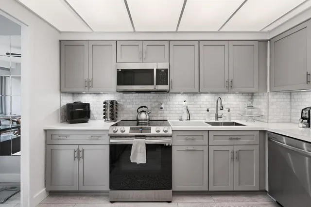 a kitchen with stainless steel appliances granite countertop a sink and a stove