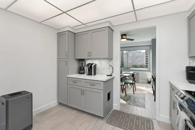 a kitchen with a stove a refrigerator and a table