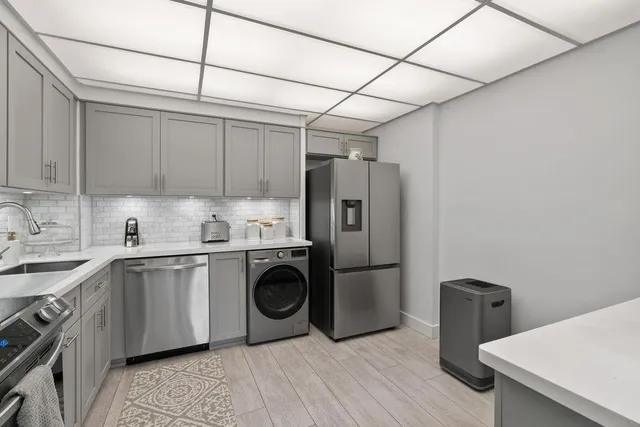 a kitchen with stainless steel appliances a refrigerator and a sink