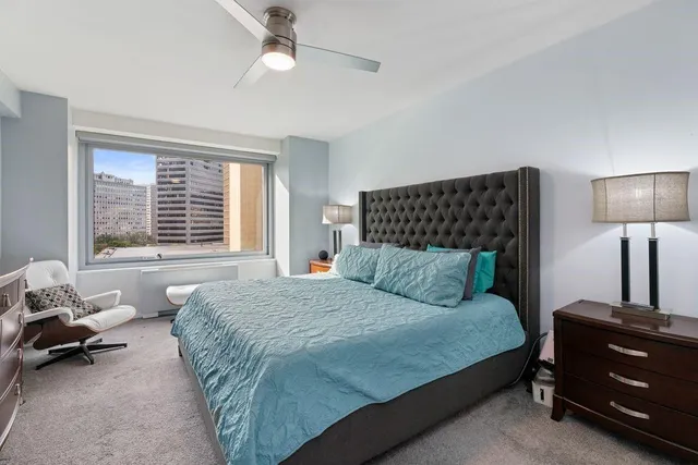 a bedroom with a bed a couch and a window