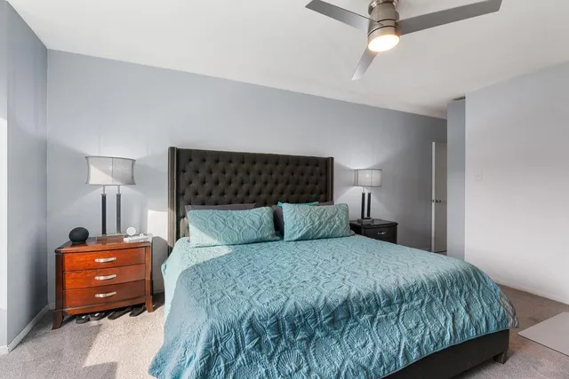 a bedroom with a bed and a lamp