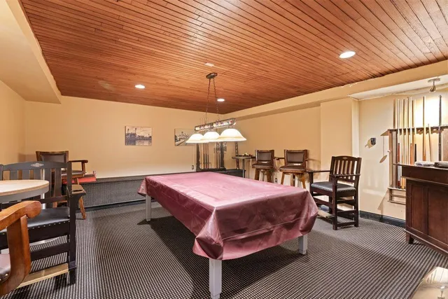 a spacious bedroom with a bed and a chandelier