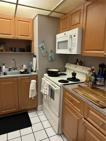 a kitchen with stainless steel appliances a sink a stove and cabinets